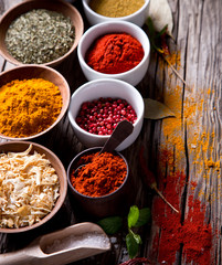 Assorted spices on wooden background