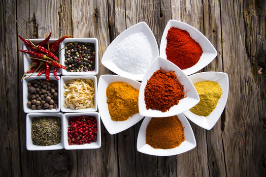 Assorted spices on wooden background