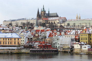 Fototapeta premium Snowy Prague gothic Castle above River Vltava, Czech Republic