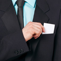 Part of body of business man who takes out business card 