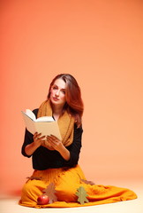 Autumn fashion girl with book orange eye-lashes