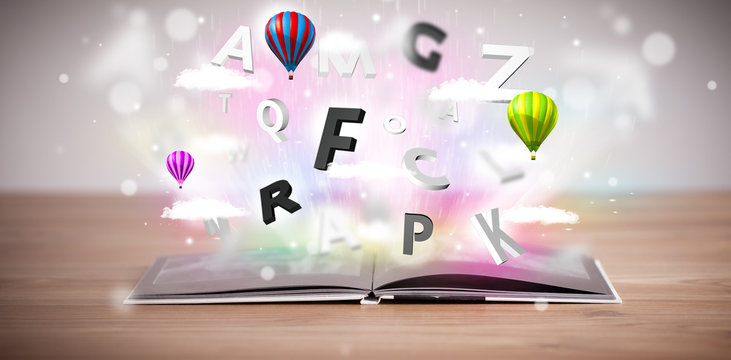 Open book with flying 3d letters on concrete background