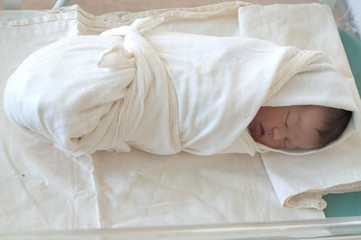 Newborn baby, wrapped in swaddling clothes