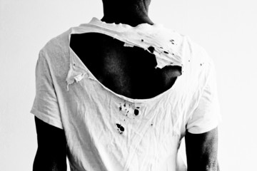 man's back with ripped t-shirt