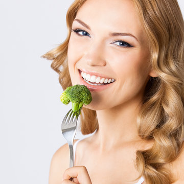 Woman Eating Broccoli, Over Gray