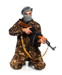 Arab nationality in camouflage suit and keffiyeh with automatic