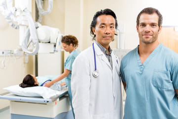 Medical Team With Patient In Examination Room