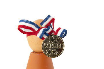 Egg with winner medal and ribbon