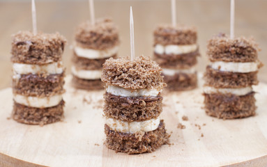 Canape biscuit with banana and walnut - chocolate cream.