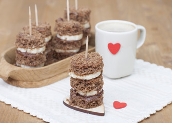 Canape biscuit with banana and walnut - chocolate cream. Cup of