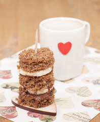 Canape biscuit with banana and walnut - chocolate cream. Cup of