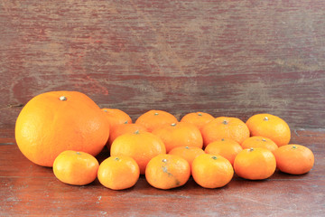 Orange fruit on wood background.