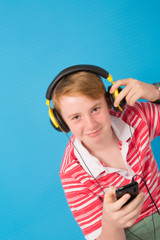 Happy young teenager listening to music