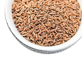 Caraway seeds in a small ceramic cup