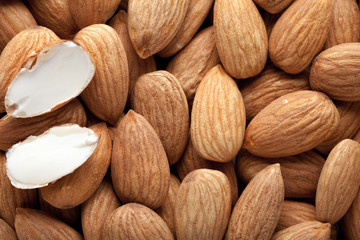 Pile of almonds close-up as background.