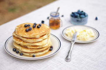 Blueberry pancakes with butter and honey