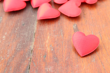 Fototapeta na wymiar Red heart on wood background