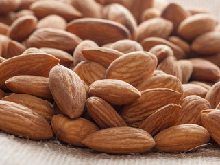 Pile of almonds close-up as background.