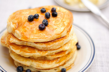 Blueberry pancakes with butter and honey
