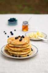 Blueberry pancakes with butter and honey