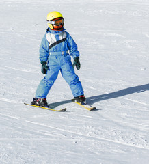 Fototapeta na wymiar Girl on skis in soft snow