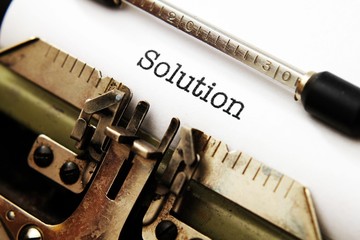 Solution  text on typewriter