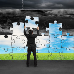 Businessman holding puzzles to assembly turning bad situation