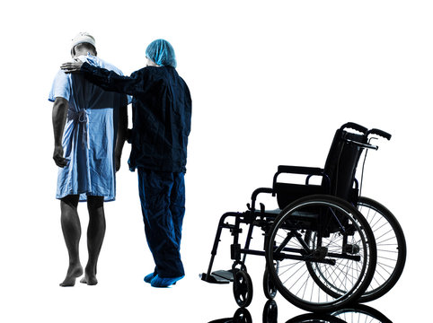 Injured Man Walking Away From  Wheelchair With Nurse Silhouette