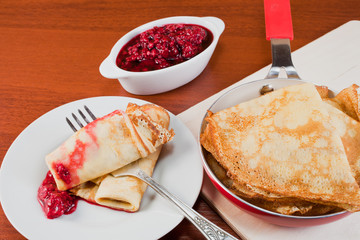 pancakes on a plate and raspberry jam