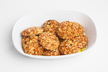 Plate of nut cookies on white background