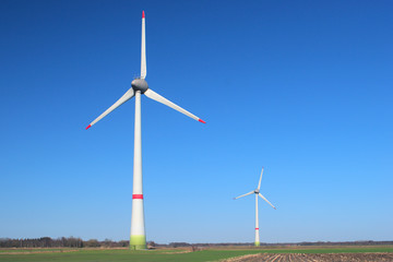 Two windmills on a cloudless, sunny day