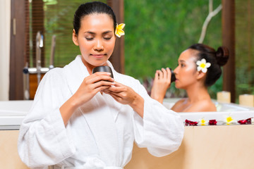 Indonesian women having wellness bath drinking tea