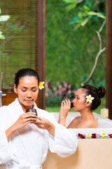 Indonesian women having wellness bath drinking tea