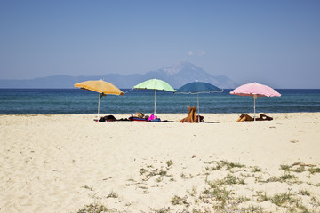 On the beach: umbrella, white sand and blue sea