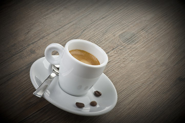 cup of coffee with cinnamon sticks and anise