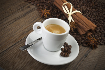 cup of coffee with cinnamon sticks and anise