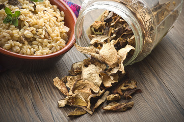 Rice and dried porcini mushrooms on table
