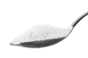 Iron spoon of baking soda close up