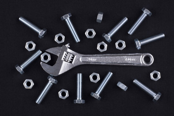 Adjustable wrench with screws and nuts