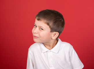 boy portrait in white shirt on red