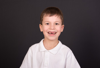 boy portrait in white shirt on black