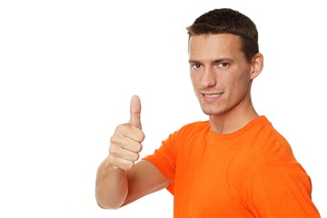Young attractive man at orange shirt shows you finger up