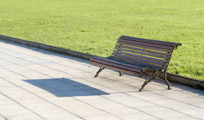wooden bench in park on sunny day