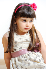 cute little fashion girl lie on a white background.