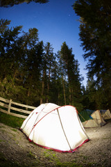 Evening lit tent in camping