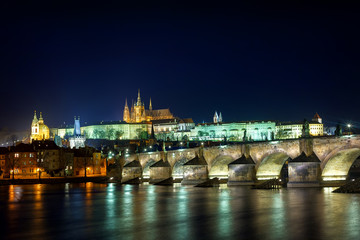 Prague Castle illuminated at night over Charles Bridge