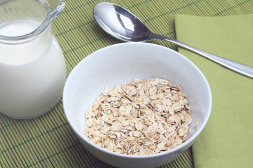 Bowl of oatmeal with milk jug