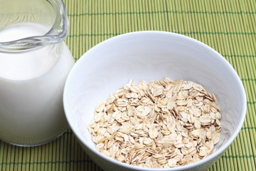 Bowl of oatmeal with milk jug