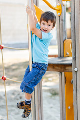 Little boy slide down on pole
