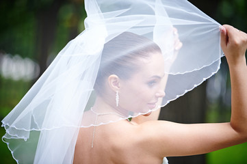 Happy bride keeps veil